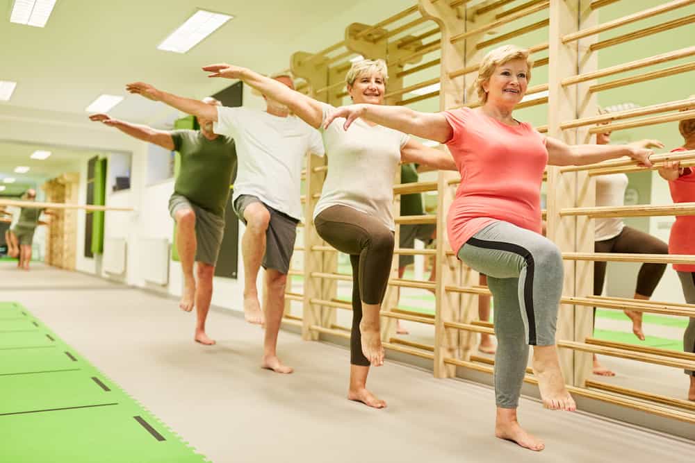 A group of seniors practicing fall prevention exercises