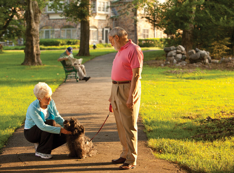 seniors walking their dog outside