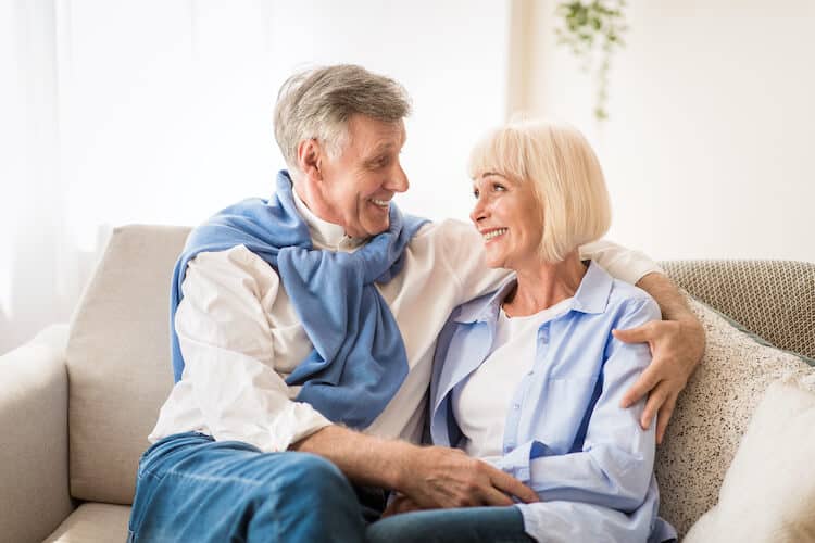 A senior couple embracing.