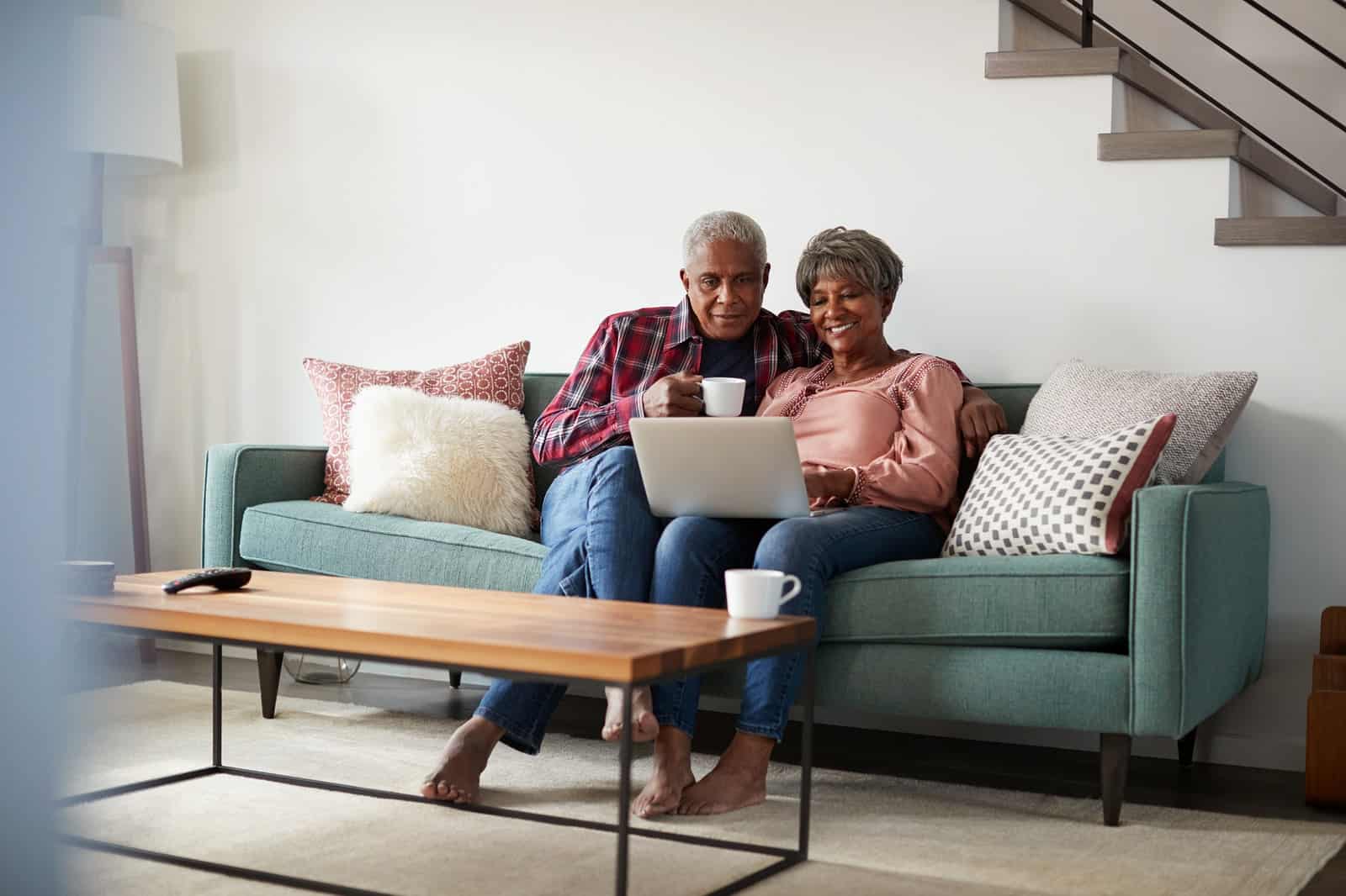Senior couple researching ways to save money for retirement.